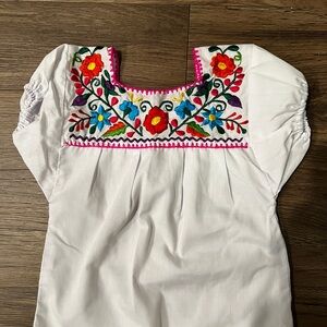 Embroidered White Top with Floral Accents